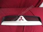 Nos Oem Mitsubishi Raider Pick Upper Painted Grille W/emblem 2009 White. Fixed Price $199.99.