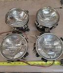 Factory Original Ford 1967 Shelby Mustang Set Of 4 Headlight Buckets & Bezels. Fixed Price $1000.00.