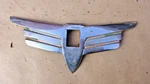 1938 Plymouth Lower Grille Ornament Original Crank Hole Surround Trim Wings. Fixed Price $750.00.