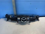 2010-2013 Mazda Center Grill Insert Gray Trim W Emblem 2011 Oem BBM4507M1. Fixed Price $125.00.