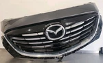 TK21-50712 13-15 Mazda CX-9 Oem Dolphin Gray Pearl Front Upper Grille Emblem. Fixed Price $235.00.